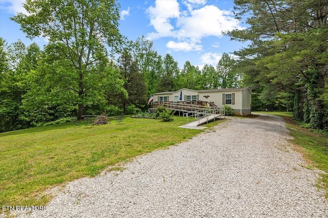 2061 Bolestown Loop, Alpine, TN 38543 - manufactured / mobile home featuring gravel driveway, a wooden deck, and a front lawn