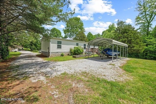 2061 Bolestown Loop, Alpine, TN 38543 - back of property with gravel driveway, a carport, and a yard