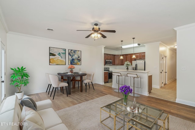 4834 Fountain View Way, Knoxville, TN 37918 - living room featuring light wood finished floors, a ceiling fan, ornamental molding, and baseboards
