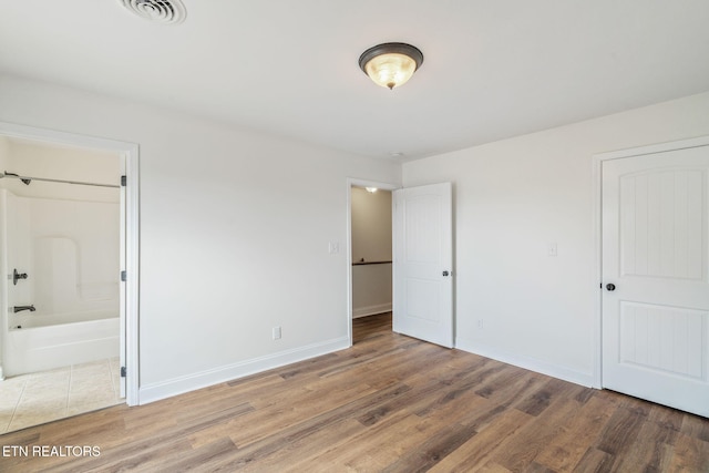 4834 Fountain View Way, Knoxville, TN 37918 - unfurnished bedroom with wood finished floors, baseboards, and connected bathroom