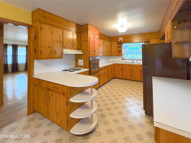 161 Cedar Ln, Rocky Top, TN 37769 - kitchen with wall oven, under cabinet range hood, a peninsula, white electric cooktop, and light countertops