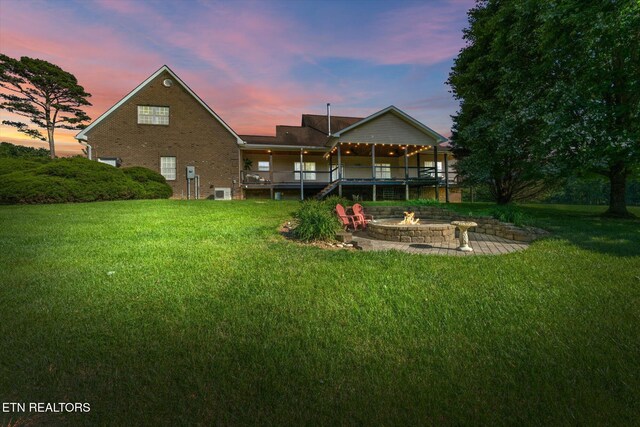 1090 Snow Hill Rd, Oakdale, TN 37829 - back of property featuring a fire pit, a yard, a deck, and brick siding