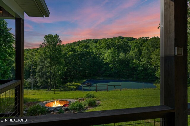 1090 Snow Hill Rd, Oakdale, TN 37829 - view of green lawn featuring an outdoor fire pit and a wooded view