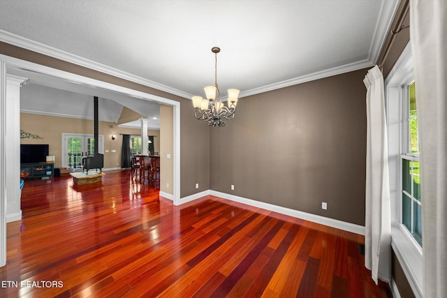 1090 Snow Hill Rd, Oakdale, TN 37829 - unfurnished room with ornate columns, a chandelier, baseboards, crown molding, and wood finished floors
