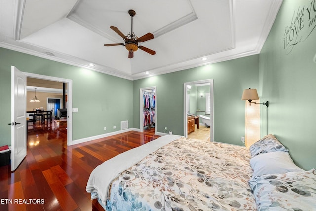 1090 Snow Hill Rd, Oakdale, TN 37829 - bedroom with a raised ceiling, wood finished floors, a walk in closet, ornamental molding, and connected bathroom