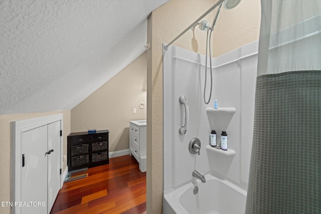 1090 Snow Hill Rd, Oakdale, TN 37829 - bathroom featuring a textured ceiling, wood finished floors, shower / bath combination with curtain, vaulted ceiling, and vanity