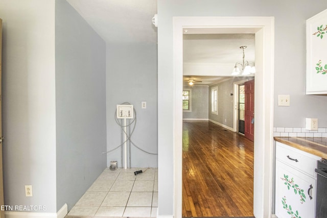 1504 Garfield St, Alcoa, TN 37701 - laundry area featuring a chandelier, light wood-type flooring, and baseboards