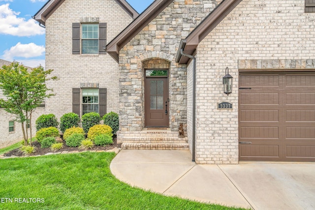 9337 Sandy Springs Ln, Knoxville, TN 37922 - doorway to property featuring a garage, stone siding, brick siding, and driveway