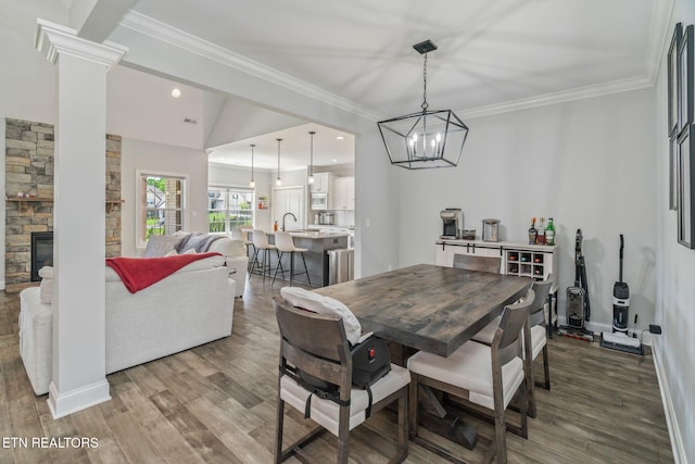 9337 Sandy Springs Ln, Knoxville, TN 37922 - dining space featuring wood finished floors, a fireplace, ornamental molding, baseboards, and recessed lighting