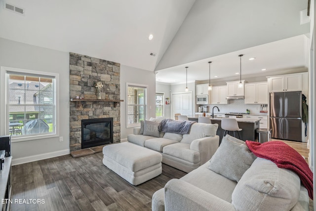 9337 Sandy Springs Ln, Knoxville, TN 37922 - living room with dark wood finished floors, recessed lighting, baseboards, a stone fireplace, and high vaulted ceiling