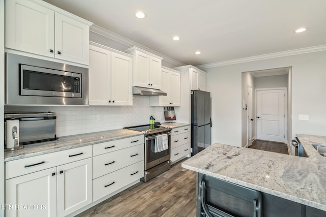 9337 Sandy Springs Ln, Knoxville, TN 37922 - kitchen with stainless steel appliances, ornamental molding, dark wood-style flooring, white cabinets, and under cabinet range hood