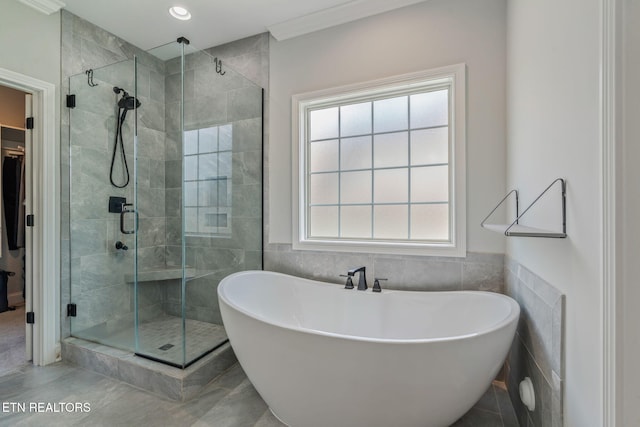 9337 Sandy Springs Ln, Knoxville, TN 37922 - bathroom with a shower stall, a freestanding bath, tile walls, and a spacious closet