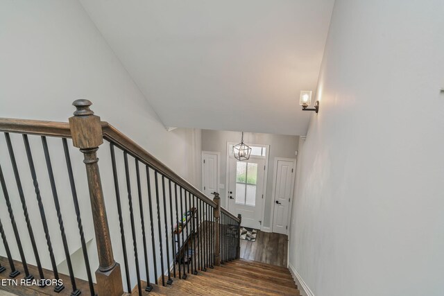 9337 Sandy Springs Ln, Knoxville, TN 37922 - stairway featuring wood finished floors, a chandelier, baseboards, and lofted ceiling