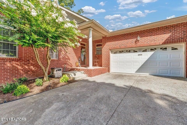 2464 Mountain Dr, Lenoir City, TN 37772 - view of front of property featuring brick siding, concrete driveway, and a garage