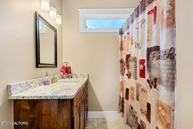 bathroom featuring vanity, a shower with curtain, and baseboards