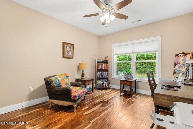 office area with wood finished floors, ceiling fan, and baseboards