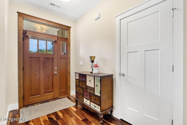 foyer entrance featuring dark wood-style flooring and baseboards