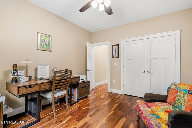 home office with wood finished floors, a ceiling fan, and baseboards