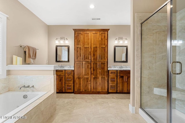 full bathroom featuring a stall shower, a bath, two vanities, and recessed lighting