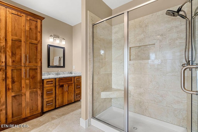 bathroom with a shower stall and vanity