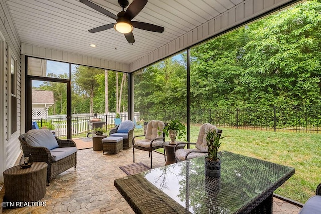 sunroom / solarium with a ceiling fan and outdoor lounge area