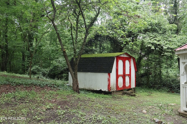 view of shed featuring a wooded view