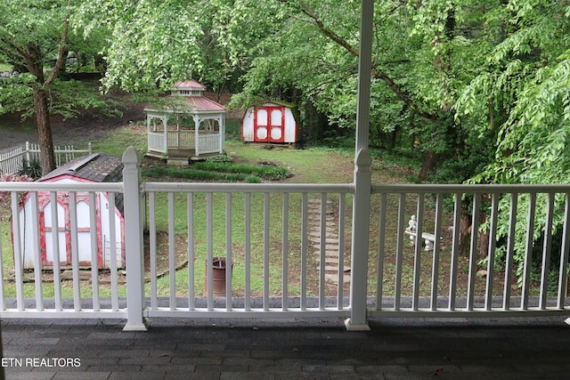 view of yard featuring a storage unit, an outdoor structure, and a gazebo