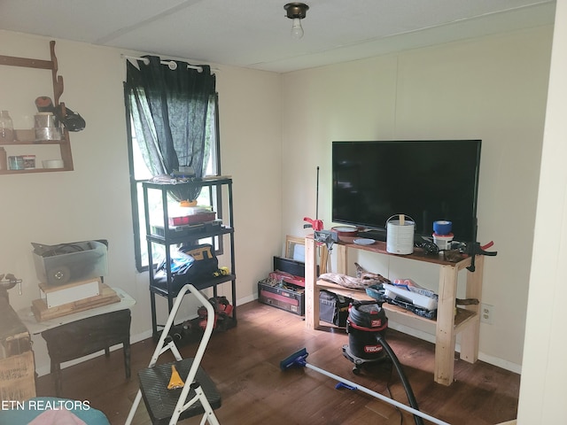 exercise room with wood finished floors and baseboards