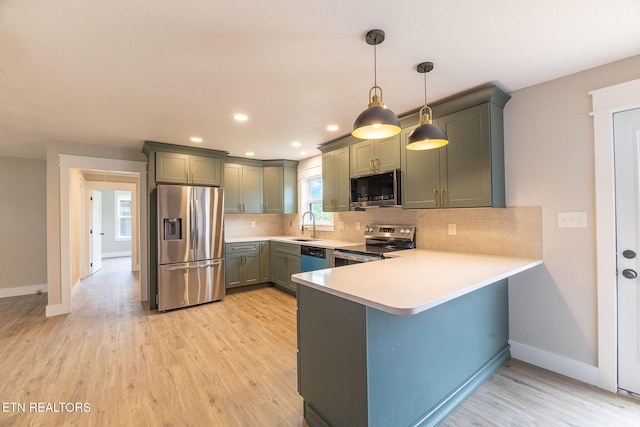 911 Valley Vista Dr, Loudon, TN 37774 - kitchen with appliances with stainless steel finishes, a peninsula, light countertops, baseboards, and light wood finished floors