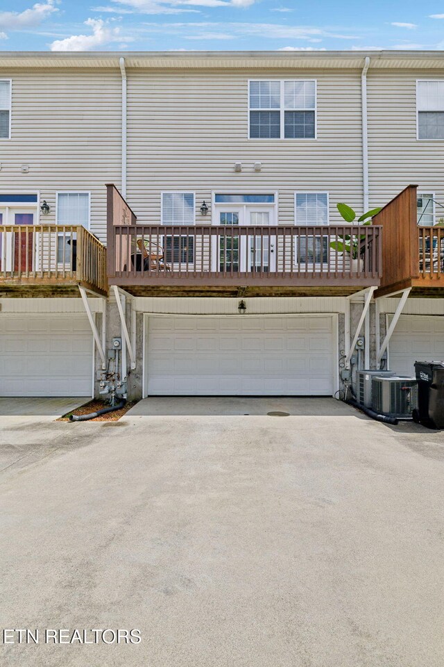 10737 Prince Albert Way, Knoxville, TN 37934 - rear view of house featuring driveway, a garage, cooling unit, and stairway