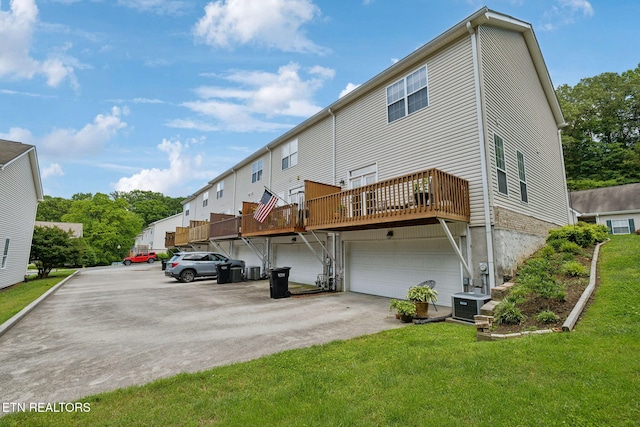 10737 Prince Albert Way, Knoxville, TN 37934 - rear view of property with a lawn, a garage, driveway, central air condition unit, and a wooden deck