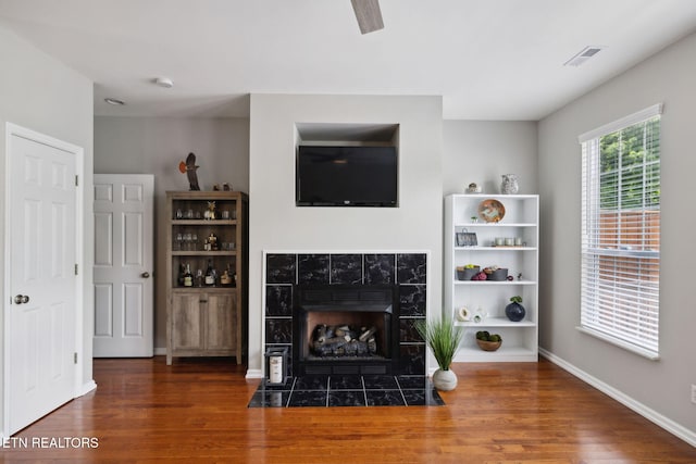 10737 Prince Albert Way, Knoxville, TN 37934 - living room featuring wood finished floors, a tiled fireplace, and baseboards