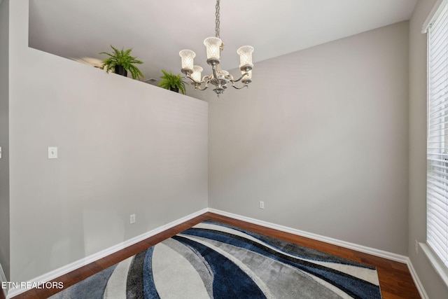 10737 Prince Albert Way, Knoxville, TN 37934 - empty room with a chandelier, dark wood finished floors, and baseboards