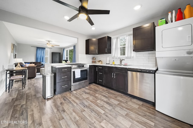 2007 NE Albert Ave, Knoxville, TN 37917 - kitchen with stainless steel appliances, stacked washer / dryer, ceiling fan, a sink, and light countertops