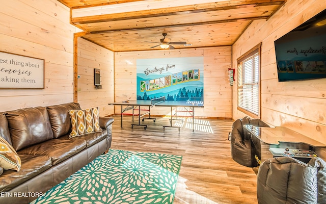 living area with wood walls, wood finished floors, wood ceiling, and ceiling fan