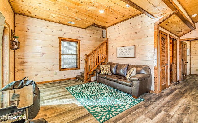 living room with wooden ceiling, wooden walls, stairway, wood finished floors, and baseboards