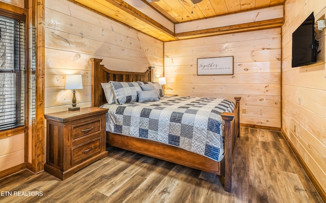 bedroom with dark wood finished floors, wooden walls, and wooden ceiling