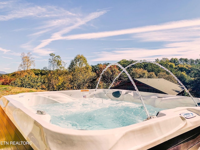 view of swimming pool featuring a hot tub