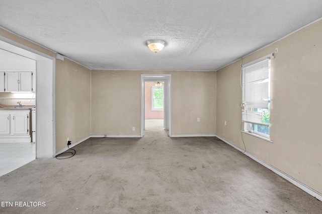 401 Offutt Spur Rd, Rocky Top, TN 37769 - empty room with a textured ceiling, light carpet, and baseboards