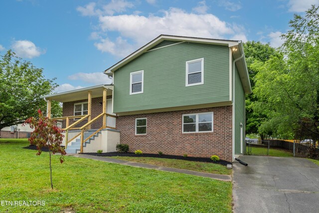 7513 Inverrary Cir, Knoxville, TN 37918 - view of front of property featuring a porch, brick siding, stairway, and driveway