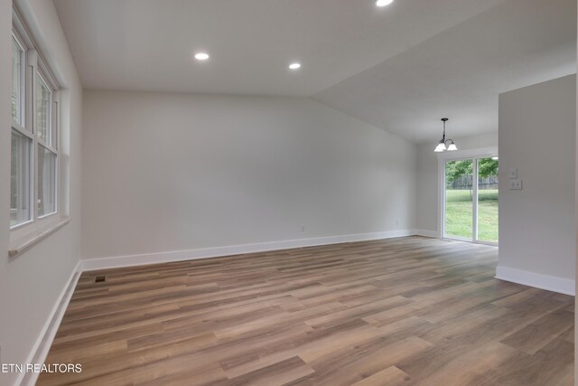 7513 Inverrary Cir, Knoxville, TN 37918 - unfurnished room featuring baseboards, a chandelier, vaulted ceiling, wood finished floors, and recessed lighting