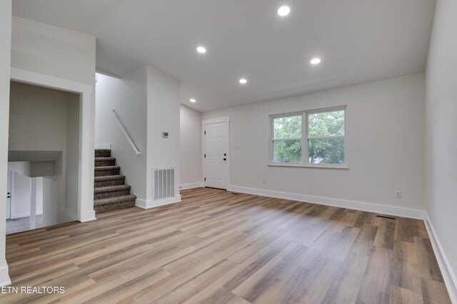 7513 Inverrary Cir, Knoxville, TN 37918 - unfurnished living room with stairs, wood finished floors, baseboards, and recessed lighting