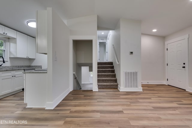 7513 Inverrary Cir, Knoxville, TN 37918 - kitchen featuring white cabinetry, light wood-type flooring, baseboards, recessed lighting, and light stone countertops