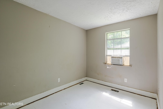 2400 Wilson Ave, Knoxville, TN 37915 - empty room with cooling unit, a textured ceiling, baseboards, and concrete flooring
