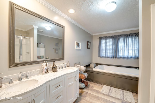 1418 Gulley River Rd, Harrogate, TN 37752 - bathroom with a textured ceiling, wood finished floors, a stall shower, a bath, and ornamental molding