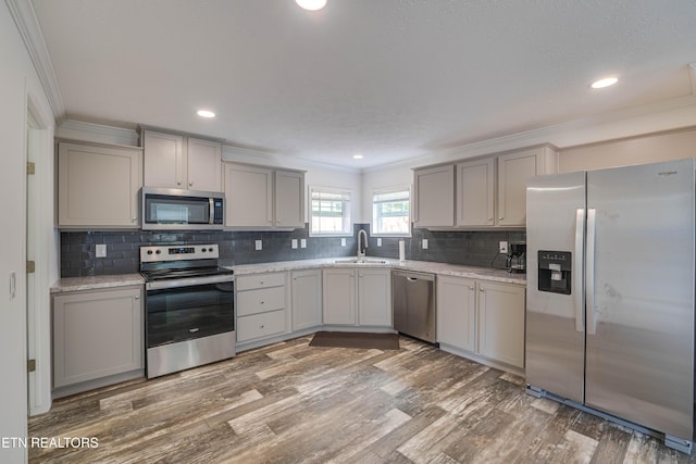 1418 Gulley River Rd, Harrogate, TN 37752 - kitchen featuring stainless steel appliances, gray cabinets, a sink, ornamental molding, and wood finished floors