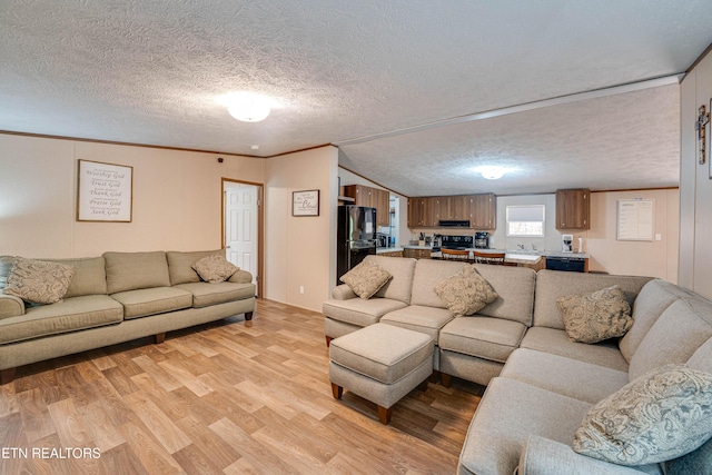 1418 Gulley River Rd, Harrogate, TN 37752 - living area with light wood finished floors, a textured ceiling, and ornamental molding
