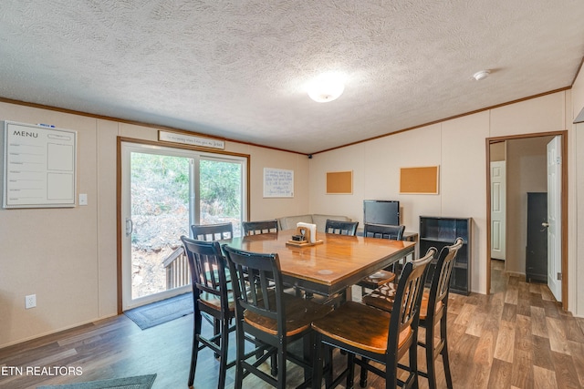 1418 Gulley River Rd, Harrogate, TN 37752 - dining area featuring ornamental molding, wood finished floors, vaulted ceiling, and a textured ceiling