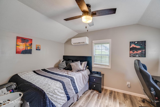 1418 Gulley River Rd, Harrogate, TN 37752 - bedroom featuring an AC wall unit, lofted ceiling, light wood finished floors, ceiling fan, and baseboards