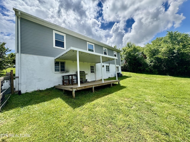 rear view of property featuring a wooden deck